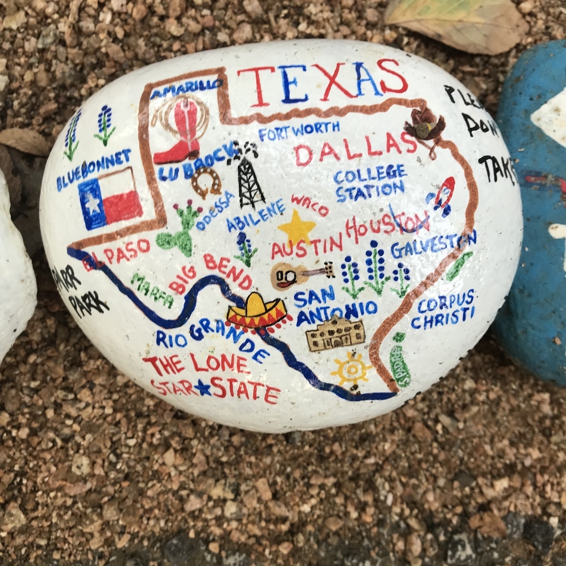 A rock at the Parr Park Rock Art Trail with major Texas cities and regions